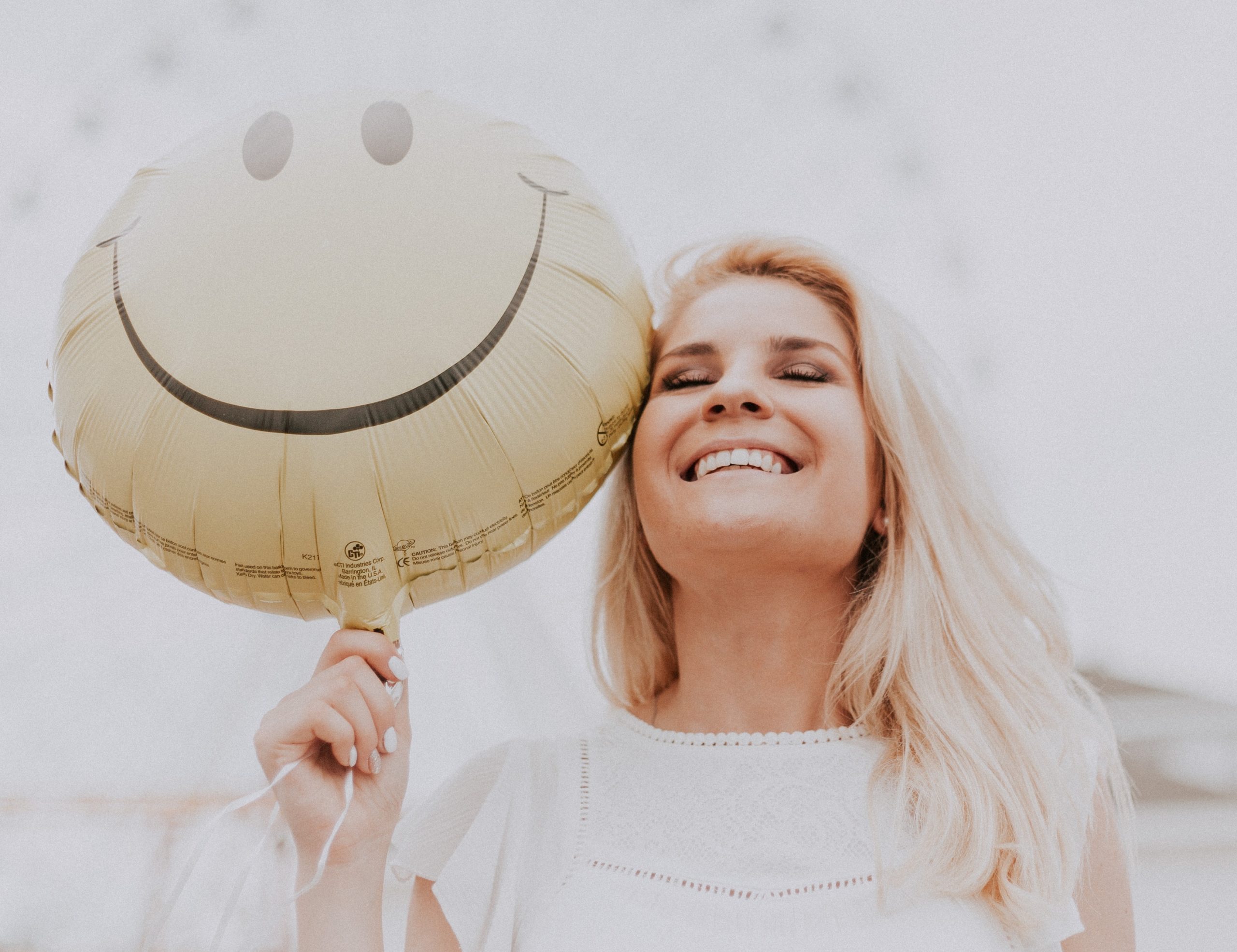 White blonde haired girl with light yellow smile balloon raleigh nc dentist