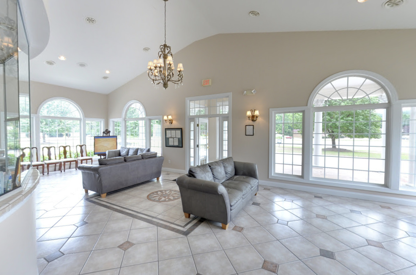 Dentist office interior lobby white floors and cream colored walls with large leather brown couches in Roseboro NC
