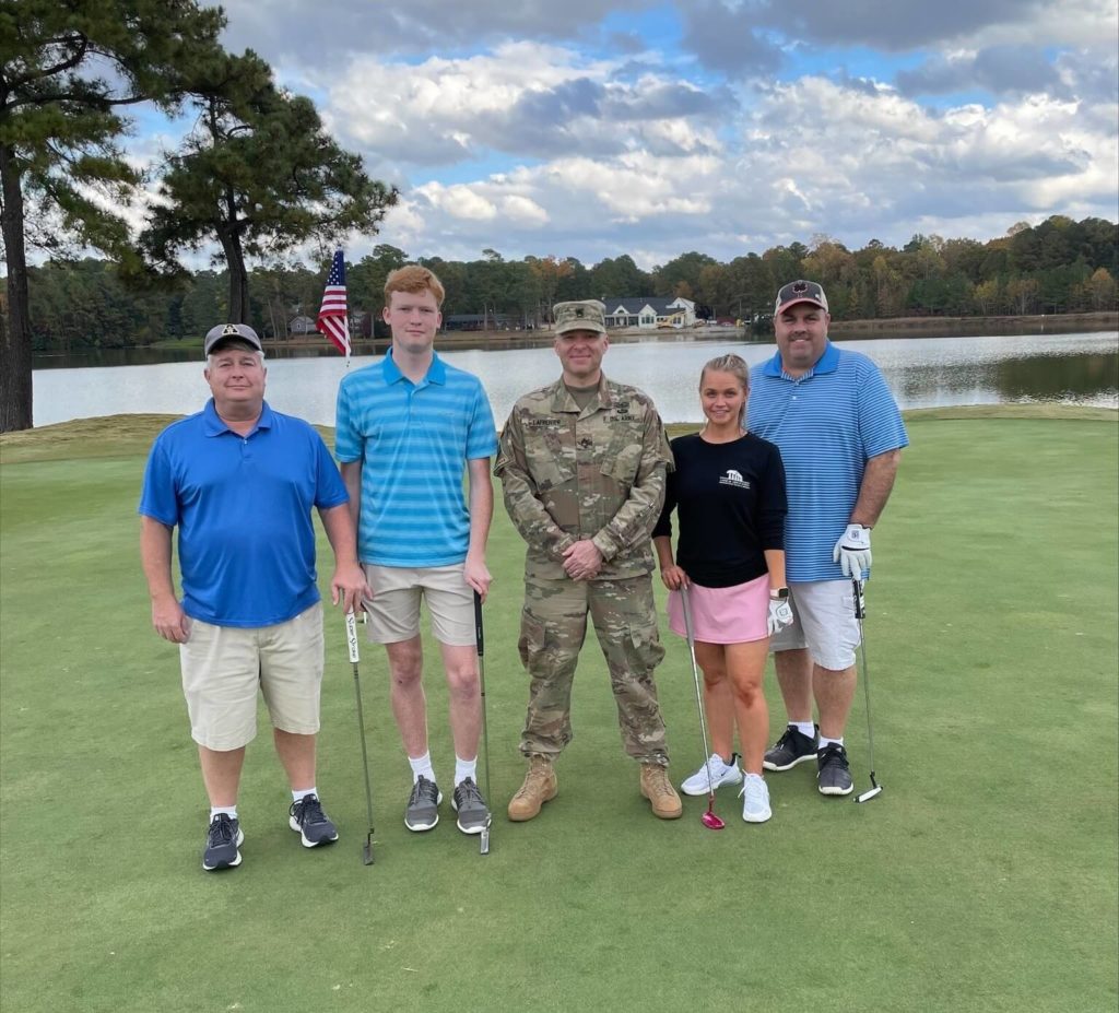 Golf team of employees at the MMIA Tee off for Troops