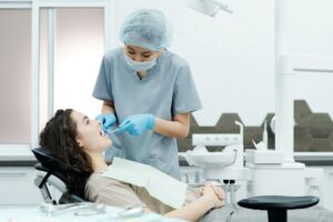 dentist cleaning woman's teeth