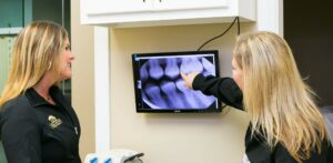 Female Dental Assistants looking at x-rays of teeth