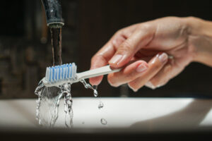 wetting toothbrush with water