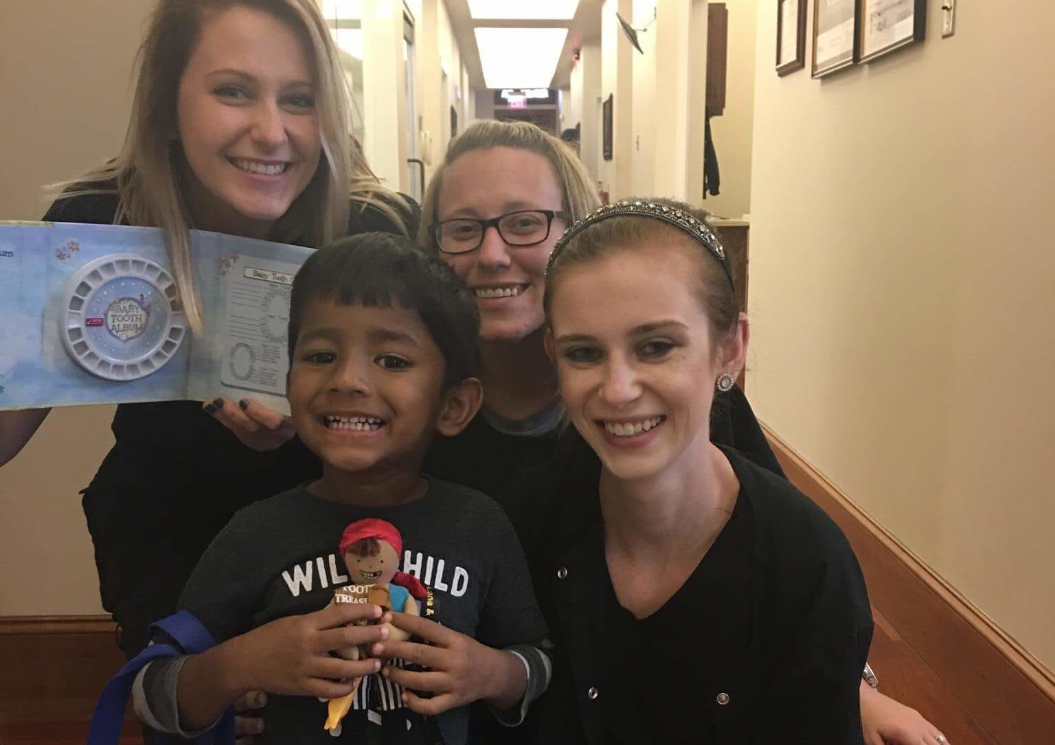 team-with-child-first-dental-visit-e1541622172526